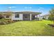Lush backyard view with a view of the home's patio at 17203 Luminous Ave, Venice, FL 34293