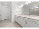 Well-lit bathroom featuring double vanity with stone countertop and modern fixtures at 17203 Luminous Ave, Venice, FL 34293