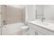 Bathroom featuring shower over tub and white vanity with stone countertop at 17203 Luminous Ave, Venice, FL 34293