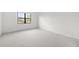 Bright and airy bedroom featuring a large window and neutral carpeting at 17203 Luminous Ave, Venice, FL 34293