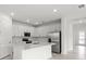 Modern kitchen with white cabinets, stainless steel appliances, and a center island at 17203 Luminous Ave, Venice, FL 34293