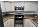 Stainless steel appliances and granite countertops in a galley kitchen at 320 Island Way # 303, Clearwater Beach, FL 33767