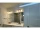 Double vanity bathroom with large mirror and modern lighting at 5633 Clearwater Ct, Lakewood Ranch, FL 34211