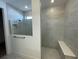 Bathroom with walk-in shower and built-in bench at 5633 Clearwater Ct, Lakewood Ranch, FL 34211