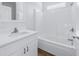 Bathroom featuring white cabinets, tub and shower combination, and modern fixtures at 719 19Th S St, St Petersburg, FL 33712