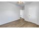 A spacious bedroom with wood-look flooring, ceiling fan, and white doors at 719 19Th S St, St Petersburg, FL 33712