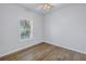 A bright bedroom with wood-look floors and ample natural light from a large window at 719 19Th S St, St Petersburg, FL 33712