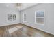 Bright bedroom with wood-look flooring, ceiling fan, and plenty of natural light at 719 19Th S St, St Petersburg, FL 33712