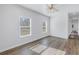 A modern bedroom features two windows, light-colored walls, and wood-look flooring at 719 19Th S St, St Petersburg, FL 33712