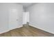 Bright bedroom with wood-look flooring, white walls, and open doorway at 719 19Th S St, St Petersburg, FL 33712