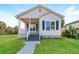 Charming single-story home with a well-maintained lawn, inviting porch, and blue shuttered windows at 719 19Th S St, St Petersburg, FL 33712