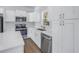 Stylish kitchen with stainless steel appliances, white cabinets and quartz countertops, perfect for cooking at 719 19Th S St, St Petersburg, FL 33712