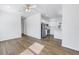 Open-concept living space with sleek appliances, ceiling fan, and wood-look flooring at 719 19Th S St, St Petersburg, FL 33712