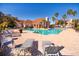 Community pool with lounge chairs and palm trees at 18128 Villa Creek Dr # 18128, Tampa, FL 33647