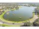 Aerial view of a lakefront community with lush landscaping and homes at 2925 Winding Trail Dr, Valrico, FL 33596