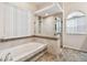 Spa-like bathroom with soaking tub and glass shower enclosure at 2925 Winding Trail Dr, Valrico, FL 33596