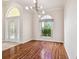 Light and airy entryway with hardwood floors and arched window at 2925 Winding Trail Dr, Valrico, FL 33596