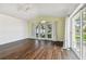 Bright Gathering room with dark hardwood floors and sliding doors to the patio at 2925 Winding Trail Dr, Valrico, FL 33596