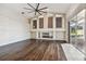 Bright living room with hardwood floors, a fireplace, and sliding doors to the pool at 2925 Winding Trail Dr, Valrico, FL 33596