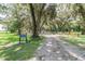 Entrance to Zeina Park, featuring a playground and shaded walking paths at 2925 Winding Trail Dr, Valrico, FL 33596