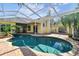 Relaxing kidney-shaped pool with a screened enclosure at 2925 Winding Trail Dr, Valrico, FL 33596