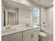 Modern bathroom with double vanity, large mirror, and a bathtub at 31464 Woodland Race Loop, Wesley Chapel, FL 33545