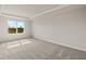 Bright bedroom featuring a large window and wall-to-wall carpet at 31464 Woodland Race Loop, Wesley Chapel, FL 33545