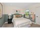 Cozy bedroom with a queen-size bed and accent wall at 31464 Woodland Race Loop, Wesley Chapel, FL 33545