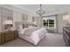 Large bedroom with plush bed, neutral decor, and water views at 31464 Woodland Race Loop, Wesley Chapel, FL 33545