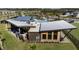 Aerial view of community clubhouse with pool and outdoor seating areas at 31471 Woodland Race Loop, Wesley Chapel, FL 33545