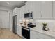 Modern kitchen with white cabinets, stainless steel appliances, and subway tile backsplash at 31471 Woodland Race Loop, Wesley Chapel, FL 33545