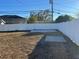 Large backyard with a wooden deck and a concrete slab at 4732 W Lawn Ave, Tampa, FL 33611