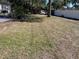 Spacious backyard with mature trees and a patio area at 4732 W Lawn Ave, Tampa, FL 33611