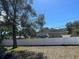 House with a white vinyl fence and large tree in the front yard at 4732 W Lawn Ave, Tampa, FL 33611