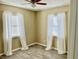 Bedroom with light walls, wood-look floors and white curtains at 4732 W Lawn Ave, Tampa, FL 33611