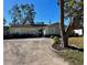 House exterior featuring a gravel driveway and landscaping at 4732 W Lawn Ave, Tampa, FL 33611