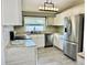 Modern kitchen with stainless steel appliances and granite counters at 4732 W Lawn Ave, Tampa, FL 33611