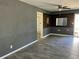 Living area with grey walls and wood-look tile floors at 4732 W Lawn Ave, Tampa, FL 33611