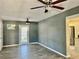 Open living room with grey walls, tile floors, and kitchen view at 4732 W Lawn Ave, Tampa, FL 33611