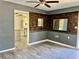 Living room with wood-look wall and view into kitchen at 4732 W Lawn Ave, Tampa, FL 33611