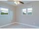 Bright bedroom with neutral walls, new flooring, and two large windows at 5135 Newton S Ave, Gulfport, FL 33707