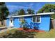 Newly renovated blue house with a landscaped front yard at 5135 Newton S Ave, Gulfport, FL 33707