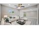 Living room featuring a comfy white couch and a large ceiling fan at 5135 Newton S Ave, Gulfport, FL 33707