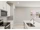 Kitchen detail showcasing white cabinets, gray backsplash, and stainless steel appliances at 5639 Brooklet Woods Dr, Wesley Chapel, FL 33545