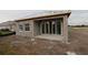 Unfinished exterior of a home with stucco siding and sliding glass doors at 633 Allora Ave, Nokomis, FL 34275