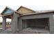 Unfinished new construction home exterior with stucco siding and a two-car garage at 633 Allora Ave, Nokomis, FL 34275