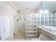 Bright bathroom with glass shower enclosure and updated fixtures at 7100 Sunset Way # 205, St Pete Beach, FL 33706