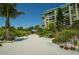 Sandy pathway to the beach with tropical plants at 7100 Sunset Way # 205, St Pete Beach, FL 33706