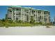 Beachfront high rise building with people on beach at 7100 Sunset Way # 205, St Pete Beach, FL 33706