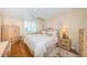 Bright bedroom with king-size bed and wood floors at 7100 Sunset Way # 205, St Pete Beach, FL 33706